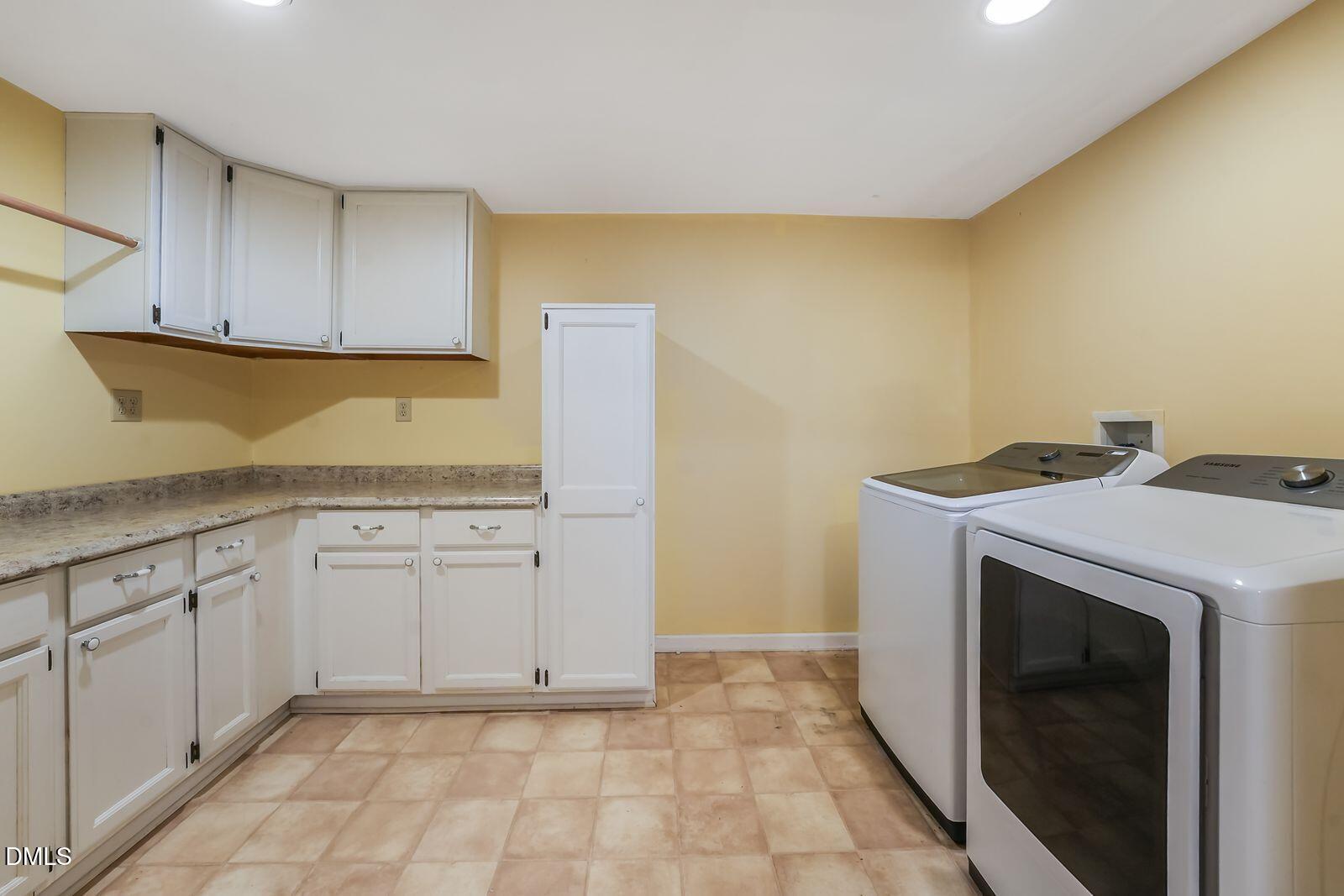 376-t K T K Allen Road Louisburg, NC 27549 - Photo 29 of 49 a utility room with granite countertop cabinets washer and dryer