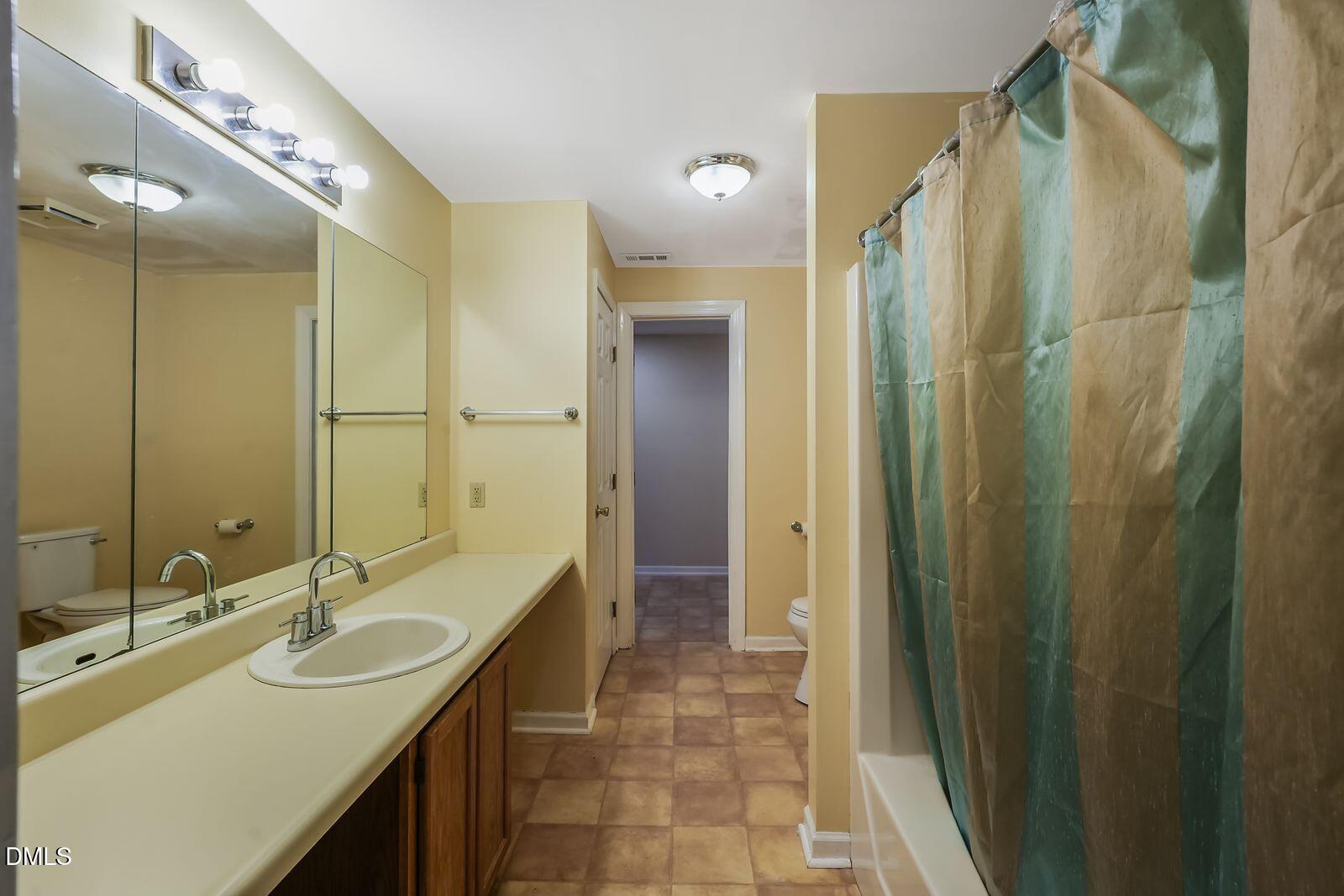 376-t K T K Allen Road Louisburg, NC 27549 - Photo 34 of 49 a bathroom with double vanity sink and a mirror