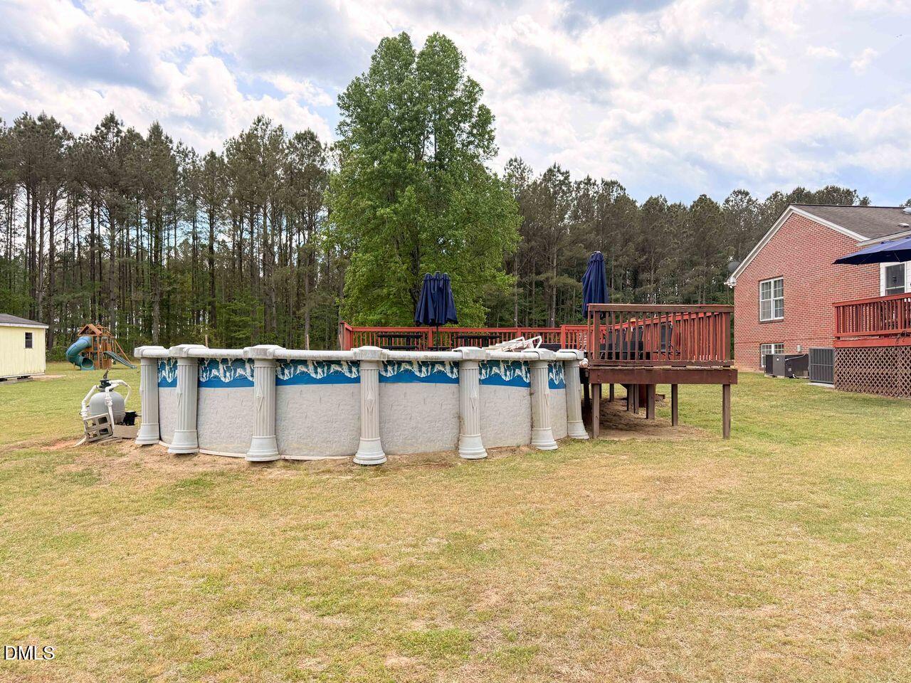 376-t K T K Allen Road Louisburg, NC 27549 - Photo 41 of 49 a view of a swimming pool with a bench and trees around
