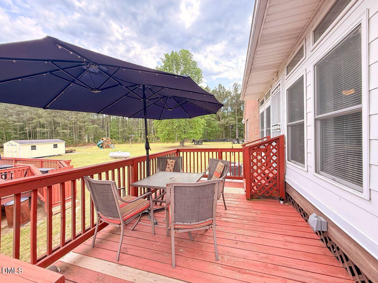 376-t K T K Allen Road Louisburg, NC 27549 - Photo 42 of 49 a view of a roof deck with table and chairs