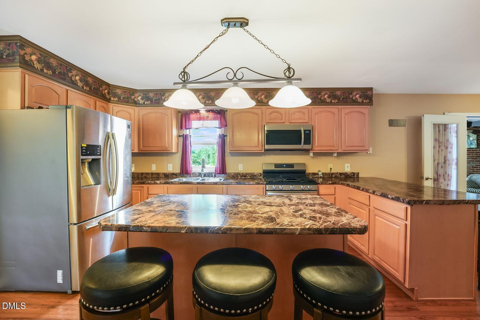 376-t K T K Allen Road Louisburg, NC 27549 - Photo 8 of 49 a kitchen with stainless steel appliances granite countertop a sink a stove and a wooden floors