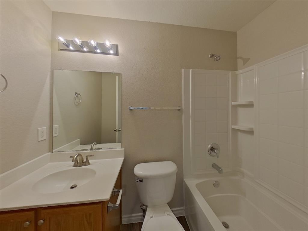 1448 Castle Ridge Road Fort Worth, TX 76140 - Photo 12 of 16 a bathroom with a sink a toilet and shower