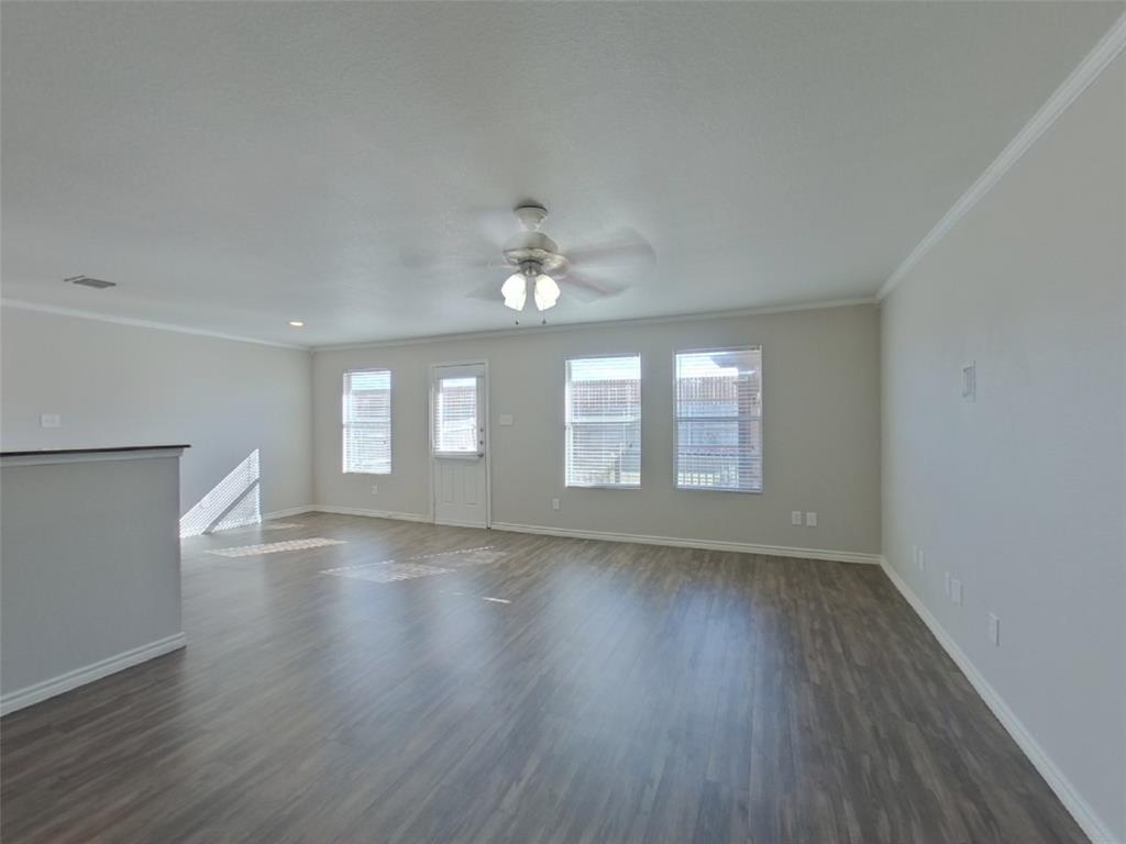 1448 Castle Ridge Road Fort Worth, TX 76140 - Photo 2 of 16 a view of an empty room with wooden floor and a window