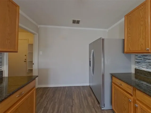 a kitchen with a refrigerator and a sink