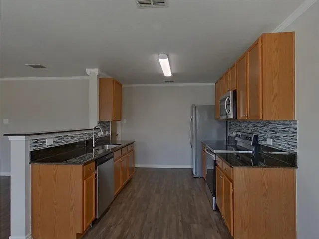 a kitchen with a sink stove and microwave