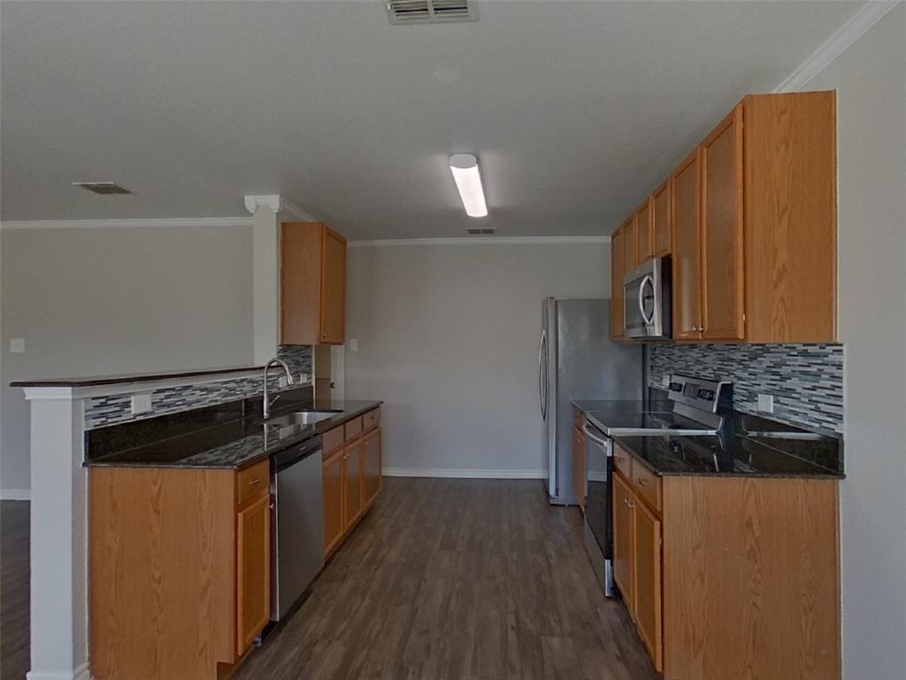 1448 Castle Ridge Road Fort Worth, TX 76140 - Photo 5 of 16 a kitchen with a sink stove and microwave