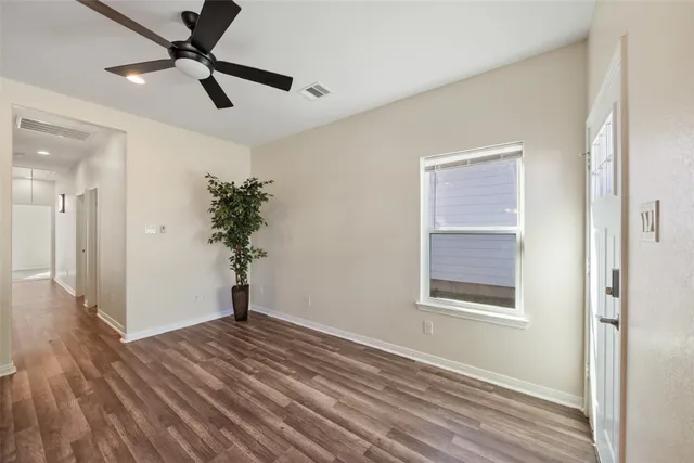 wooden floor in an empty room with a window