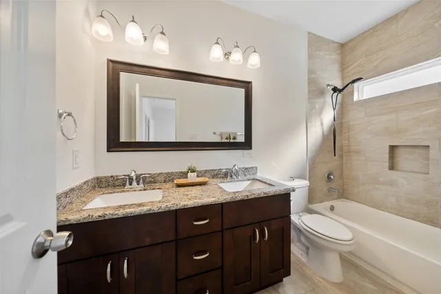 a bathroom with a double vanity sink and a mirror