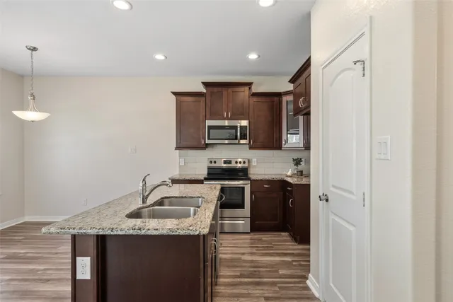 a kitchen with a sink a stove and refrigerator