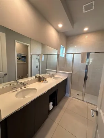 a bathroom with a double vanity sink and mirror