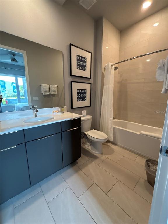 7740 Sandy Ridge Drive, Unit 131 Reunion, FL 34747 - Photo 16 of 27 a bathroom with a sink a toilet and shower