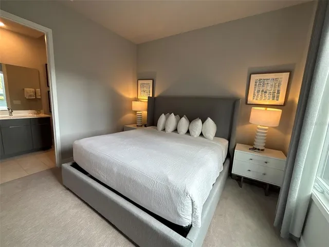 a bedroom with a bed and a night stand