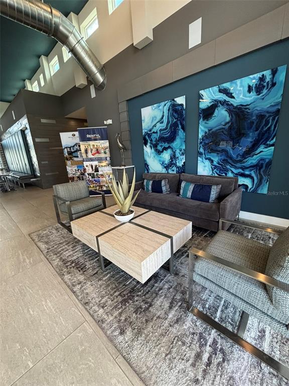 7740 Sandy Ridge Drive, Unit 131 Reunion, FL 34747 - Photo 21 of 27 a living room with furniture and a flat screen tv