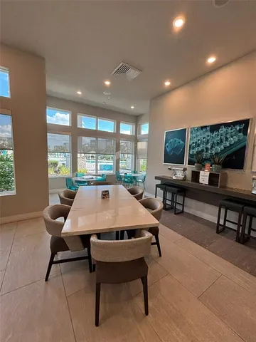 a dining room with a table and chairs