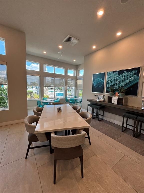7740 Sandy Ridge Drive, Unit 131 Reunion, FL 34747 - Photo 25 of 27 a dining room with a table and chairs