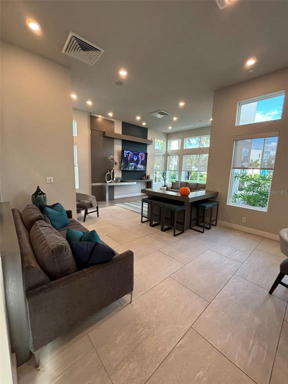 7740 Sandy Ridge Drive, Unit 131 Reunion, FL 34747 - Photo 26 of 27 a living room with furniture a window and kitchen view