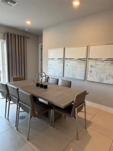 a dining room with furniture and a window