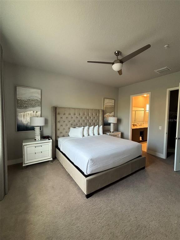 7740 Sandy Ridge Drive, Unit 131 Reunion, FL 34747 - Photo 7 of 27 a bedroom with a bed and a chandelier