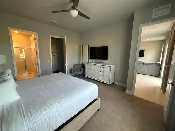 a bedroom with a bed and a flat screen tv