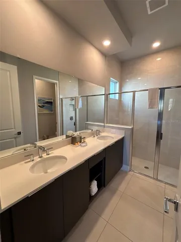 a large bathroom with a double vanity sink and a mirror