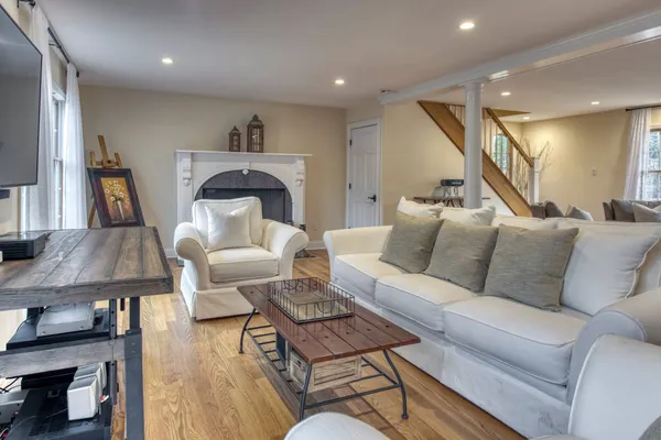 a living room with furniture and a wooden floor
