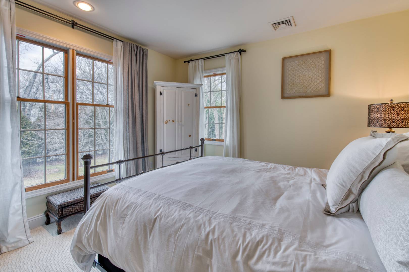 1532 Noyack Road Southampton, NY 11968 - Photo 7 of 15 a bedroom with a bed and a large window