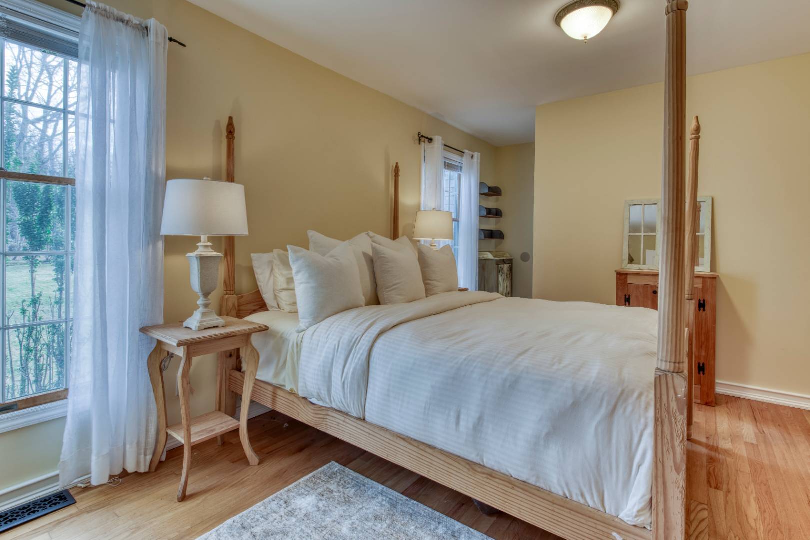 1532 Noyack Road Southampton, NY 11968 - Photo 8 of 15 a bedroom with a bed and a lamp on table