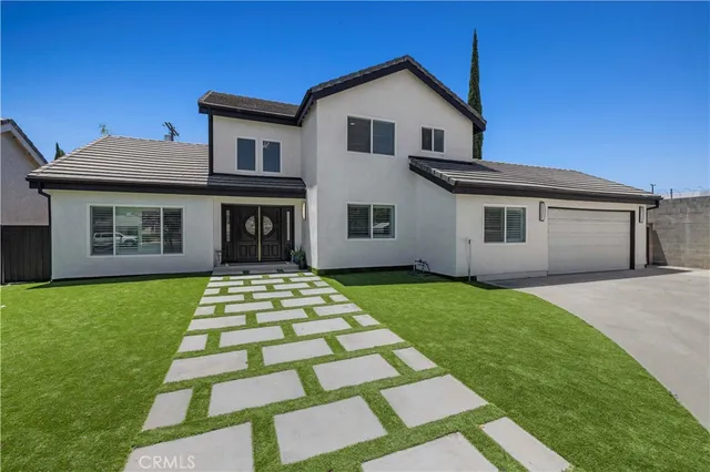 a front view of a house with a garden