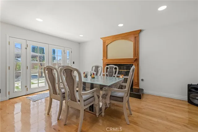 a view of an empty room with cabinet and wooden floor