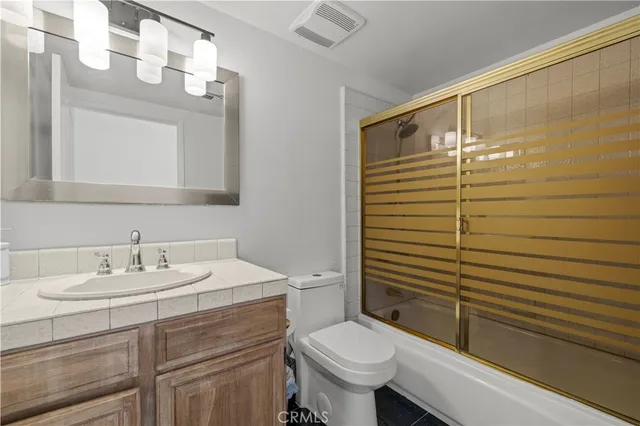 a bedroom with a bed and a view of kitchen