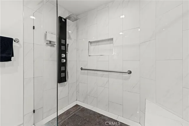 a living room with a bed furniture and a potted plant