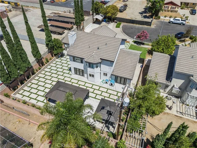 a view of a patio with a table and chairs under an umbrella