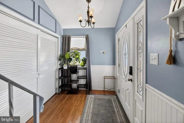 a view of a hallway and a livingroom with furniture