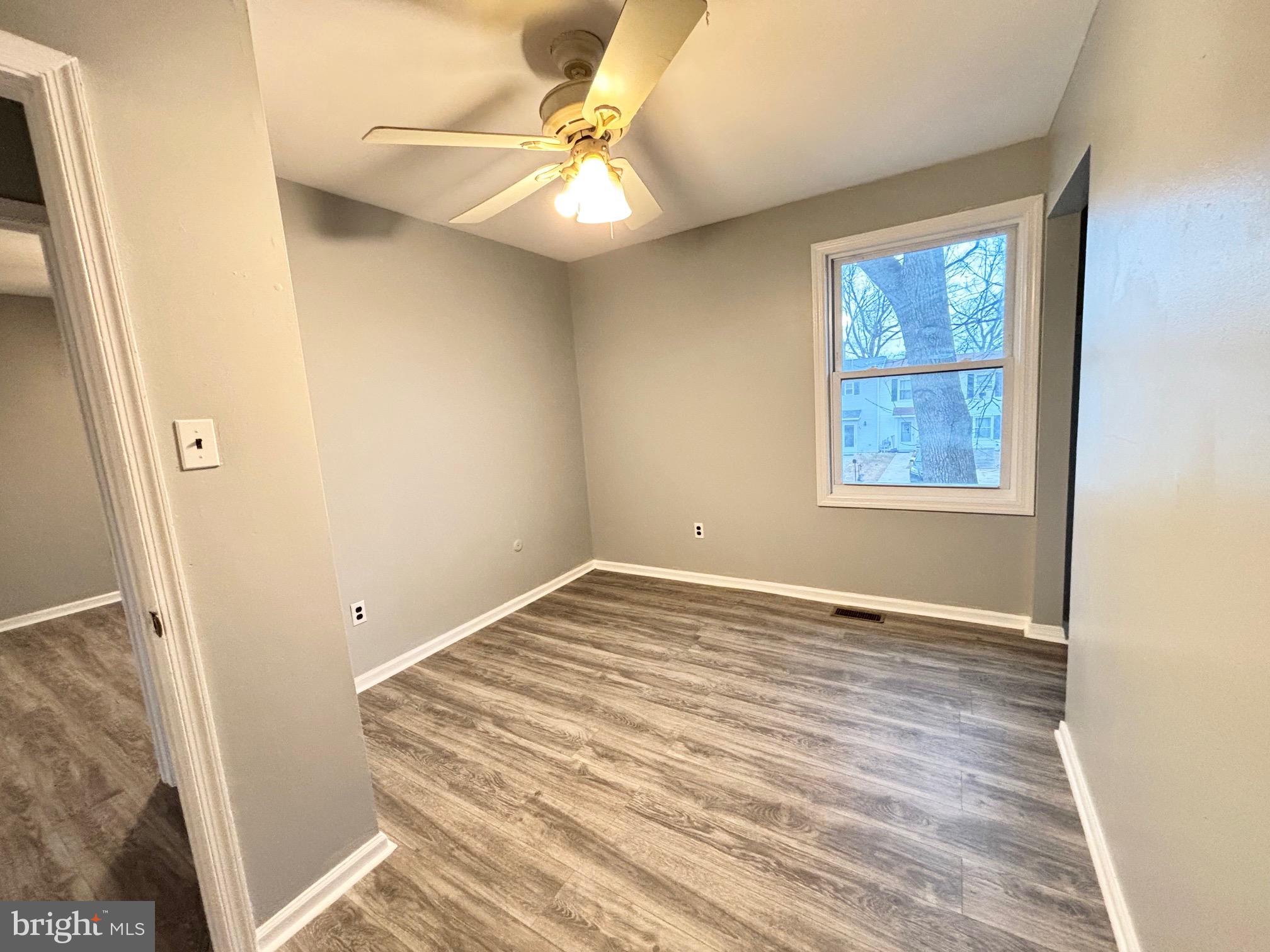 61 Berkshire Road Sicklerville, NJ 08081 - Photo 12 of 14 an empty room with a window and wooden floor