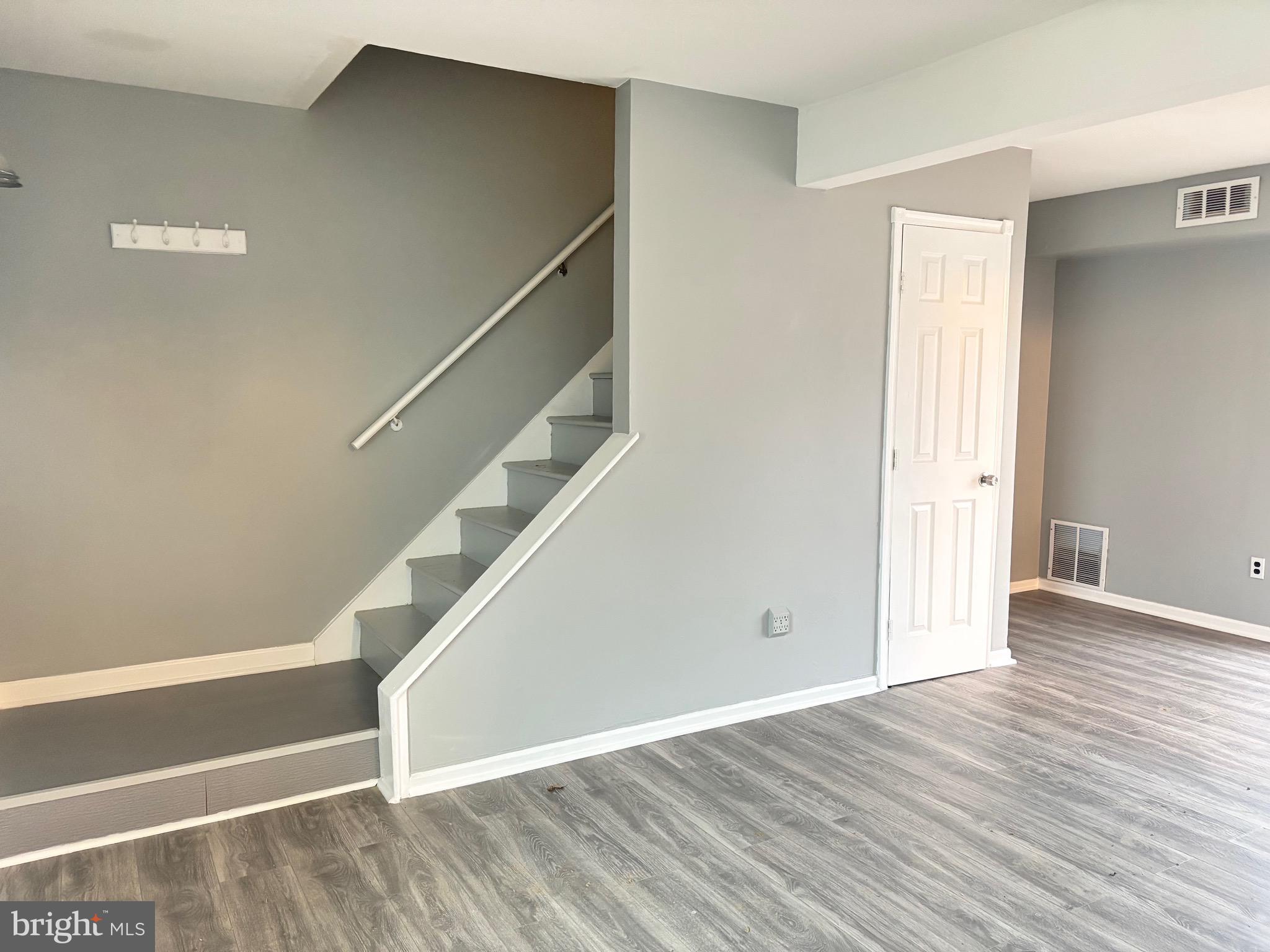 61 Berkshire Road Sicklerville, NJ 08081 - Photo 2 of 14 a view of an empty room with wooden floor and stairs