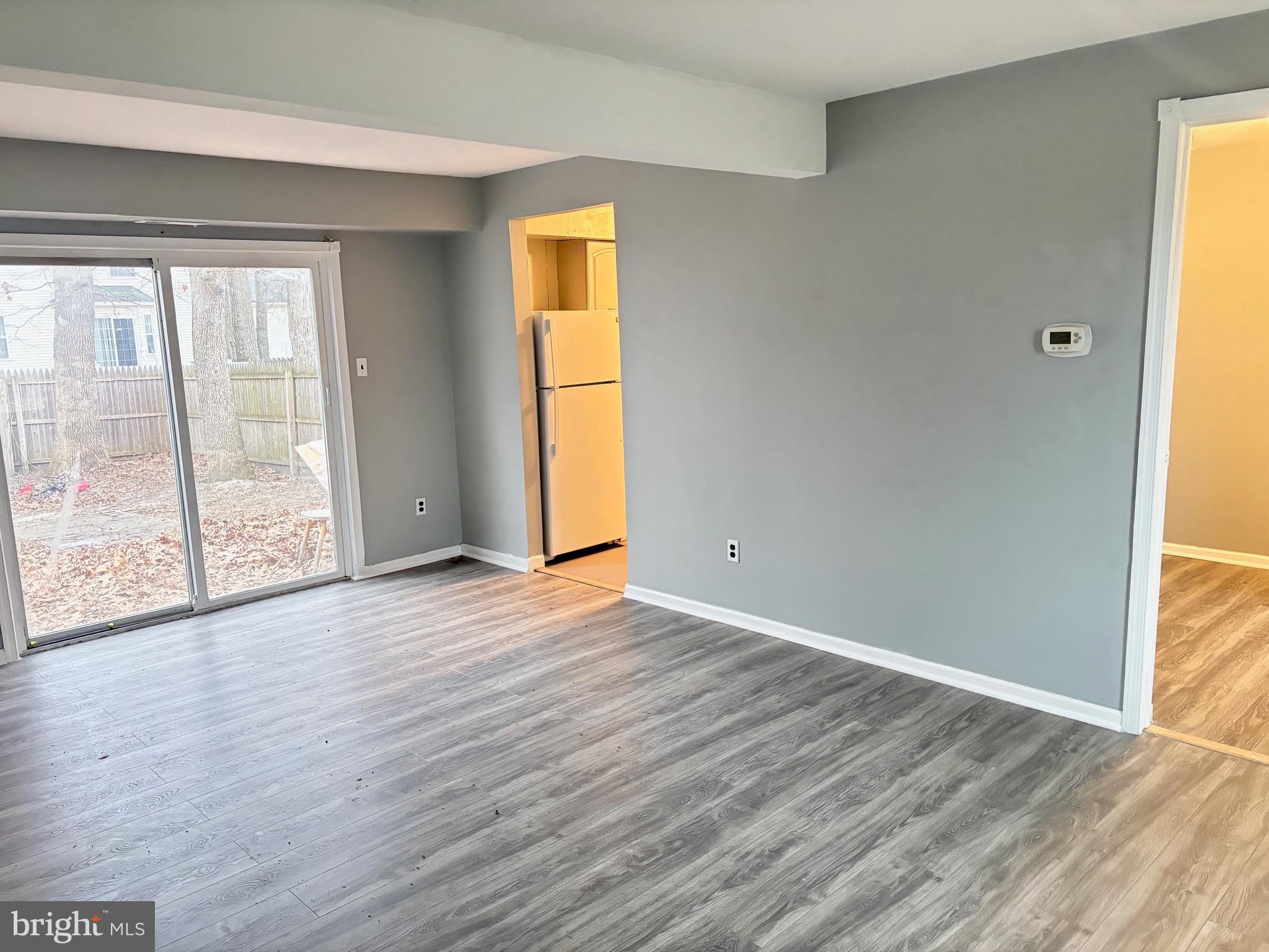 61 Berkshire Road Sicklerville, NJ 08081 - Photo 3 of 14 an empty room with wooden floor and windows