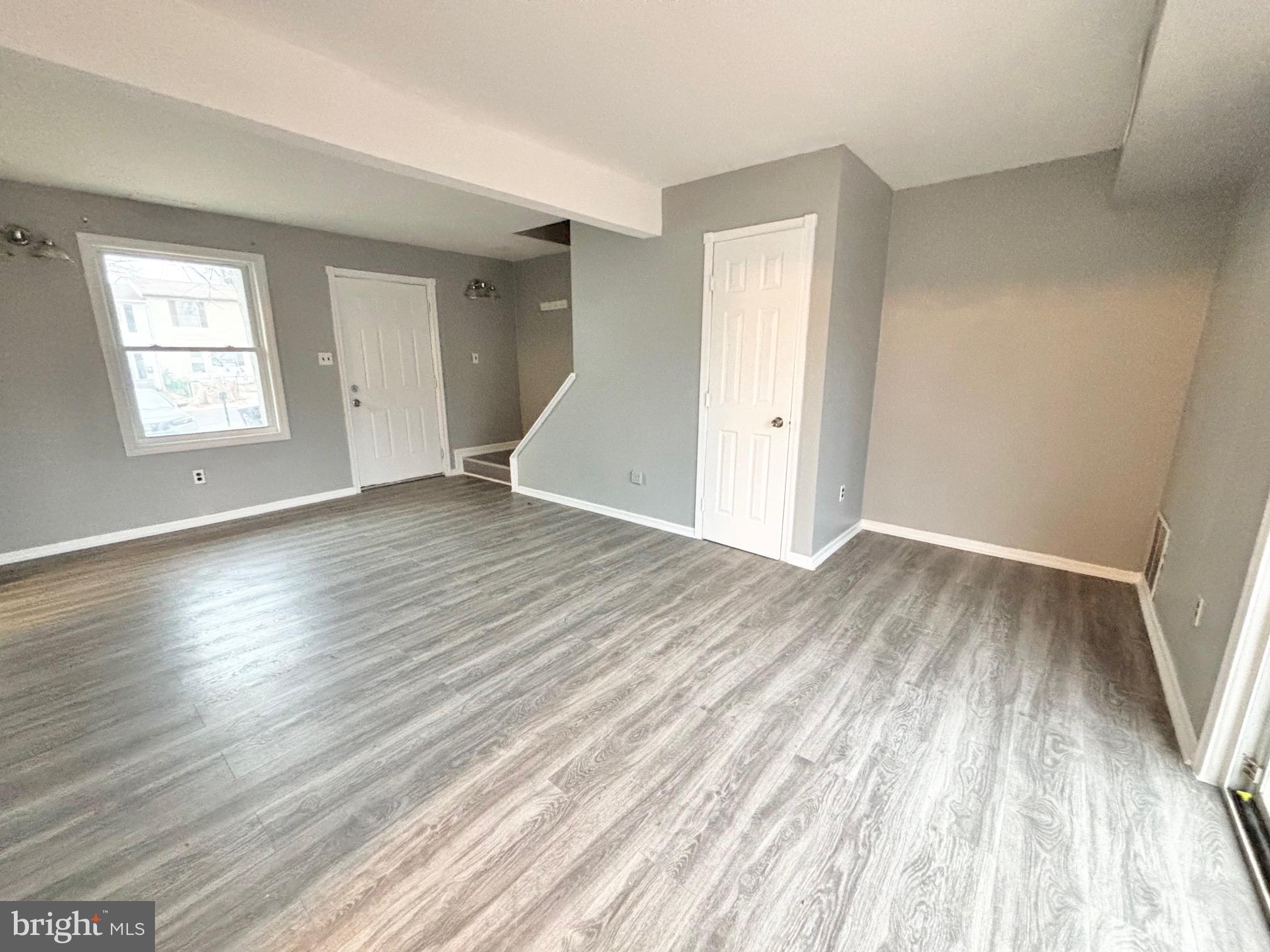 61 Berkshire Road Sicklerville, NJ 08081 - Photo 4 of 14 an empty room with wooden floor and windows
