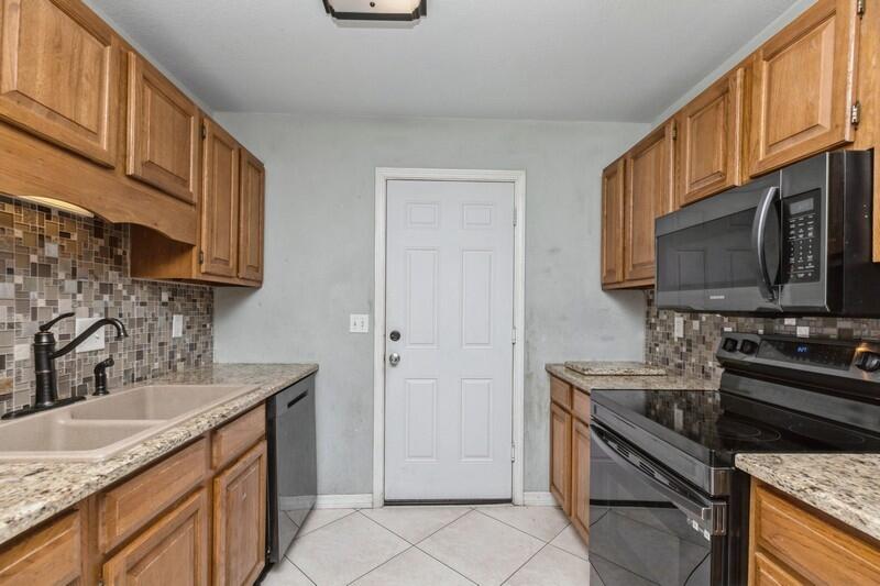 14 Gardner Drive Shalimar, FL 32579 - Photo 11 of 27 a kitchen with stainless steel appliances granite countertop a sink stove and microwave