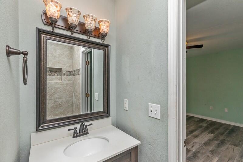 14 Gardner Drive Shalimar, FL 32579 - Photo 16 of 27 a bathroom with a sink a mirror and shower