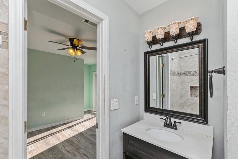 14 Gardner Drive Shalimar, FL 32579 - Photo 17 of 27 a bathroom with a sink mirror and vanity