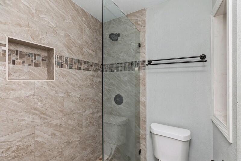 14 Gardner Drive Shalimar, FL 32579 - Photo 19 of 27 a bathroom with a shower and a toilet