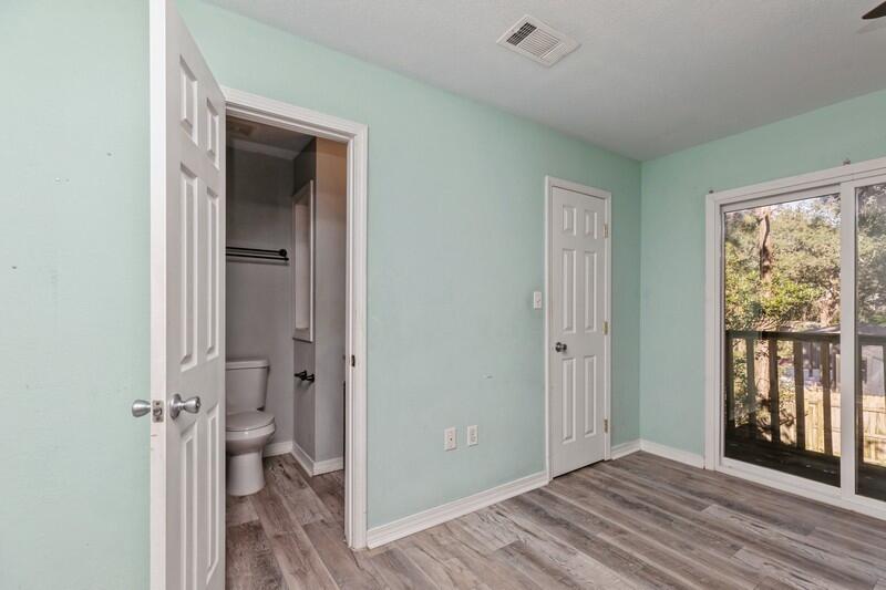 14 Gardner Drive Shalimar, FL 32579 - Photo 21 of 27 a view of a room with a large window and wooden floor