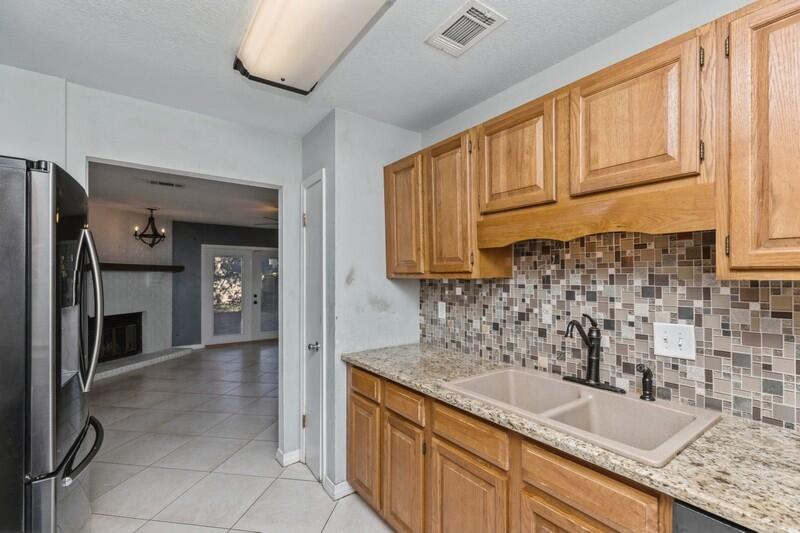 14 Gardner Drive Shalimar, FL 32579 - Photo 9 of 27 a kitchen with granite countertop a sink stainless steel appliances a counter space and cabinets