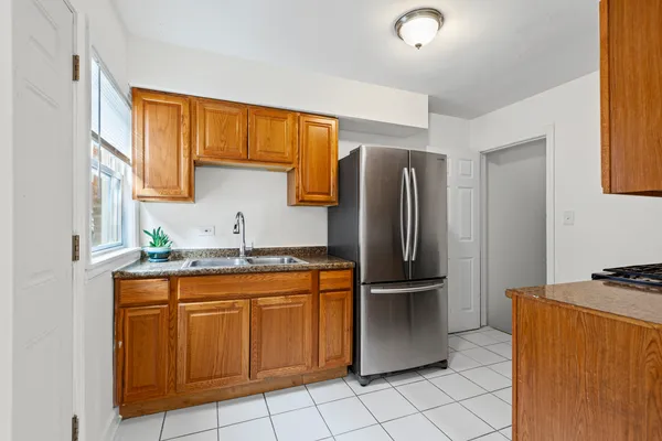 a kitchen with stainless steel appliances granite countertop a refrigerator and a sink