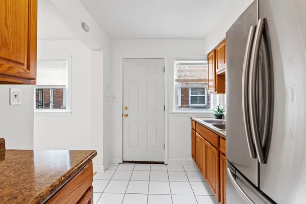 a kitchen with stainless steel appliances granite countertop a refrigerator and a sink