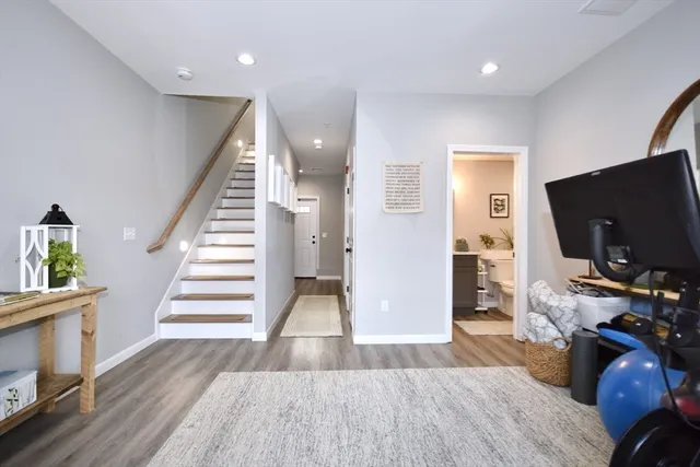 a view of a livingroom with wooden floor and furniture