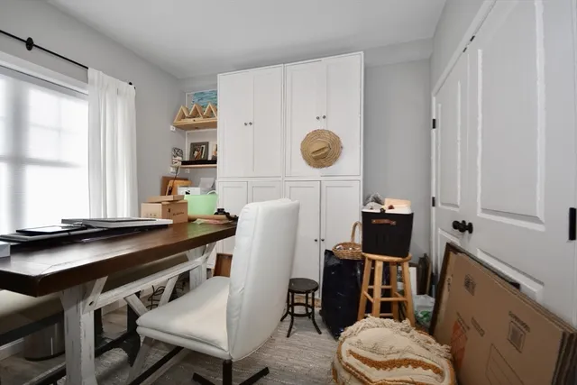 a kitchen with a sink cabinets and wooden floor