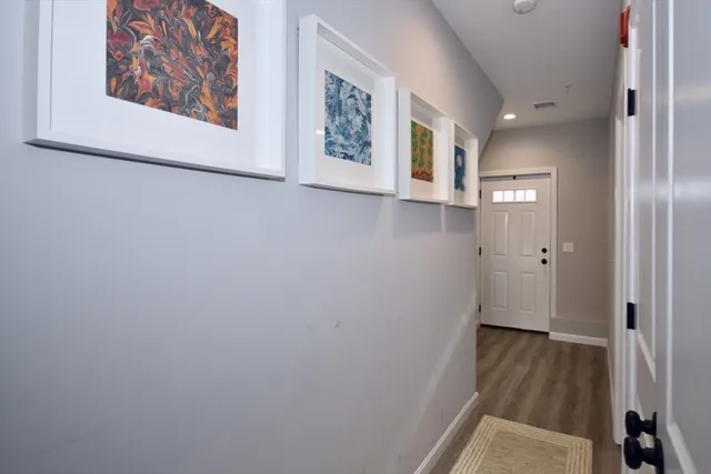 a view of a hallway with wooden floor