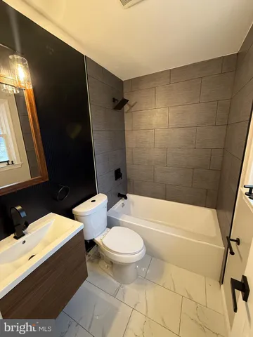 a bathroom with a toilet a sink and bathtub