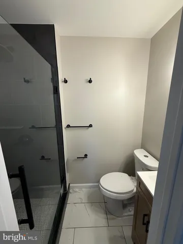 a white toilet sitting next to a sink